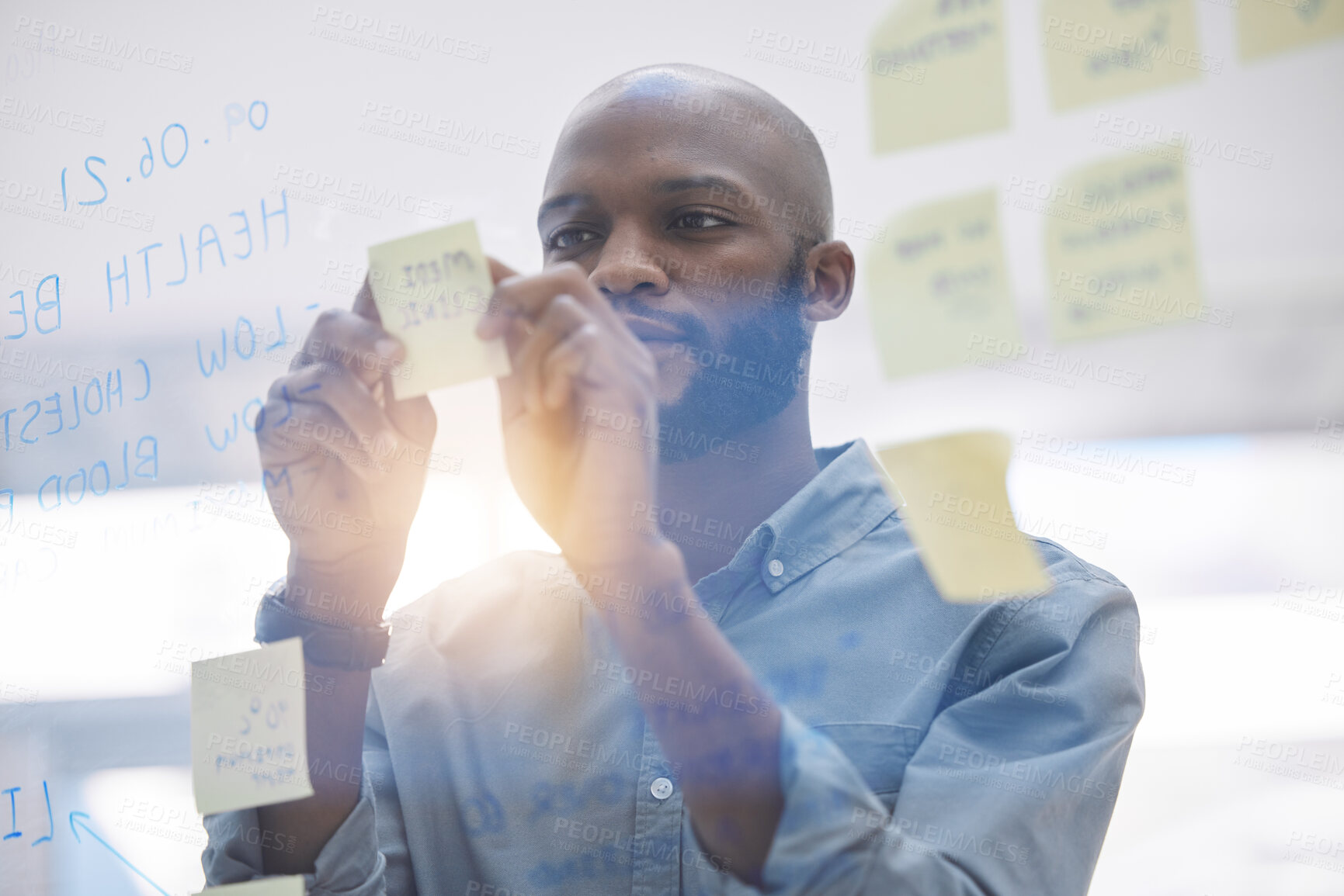 Buy stock photo Brainstorming, writing and business man on glass board for planning, schedule and scrum or agile solution. Thinking, ideas and focus of African person on window sticky notes, job priority or reminder