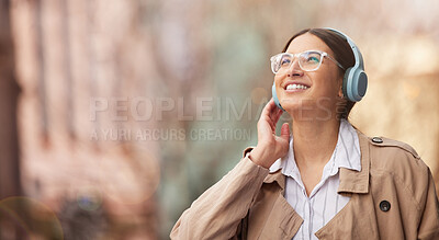 Buy stock photo Shot of a beautiful young woman happily waiting for a taxi to arrive while out in the city