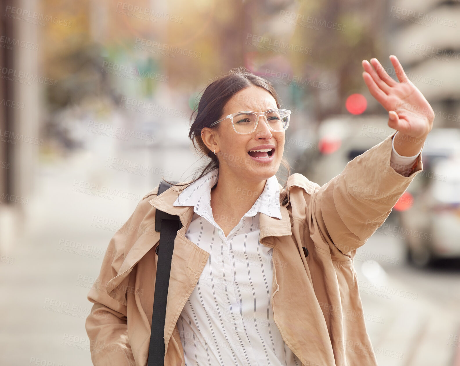 Buy stock photo Shot of a beautiful young woman trying to hail a cab while out in the city