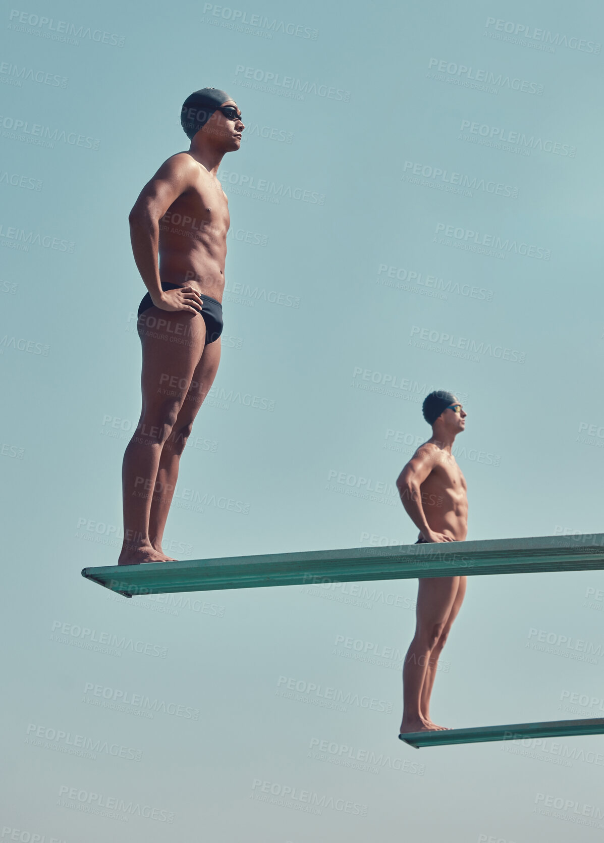 Buy stock photo Full length shot of two handsome young male athletes standing on diving boards outside