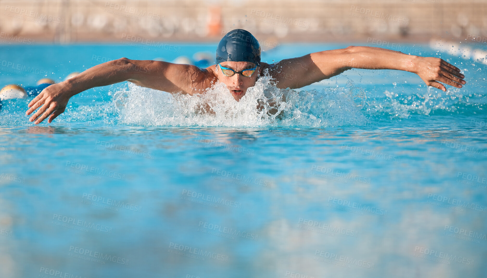 Buy stock photo Shot of a handsome young male athlete swimming in an olympic-sized pool