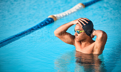 Buy stock photo Shot of a handsome young male athlete swimming in an olympic-sized pool