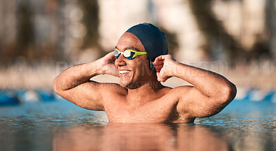 Buy stock photo Shot of a handsome young male athlete swimming in an olympic-sized pool