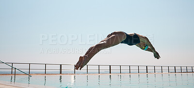 Buy stock photo Shot of a young athlete diving into an olypmic-sized swimming pool