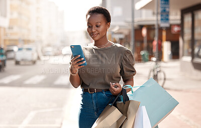 Buy stock photo Shopping, bag and phone with black woman in city for social media, networking and communication. Fashion, retail and luxury with female customer in Nigeria Town for contact, ecommerce app and sale
