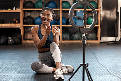 Buy stock photo Fitness, woman and phone blog for live stream exercise at gym on platform or app. Influencer, training or health vlog with black person or coach talking to social media or virtual audience with light