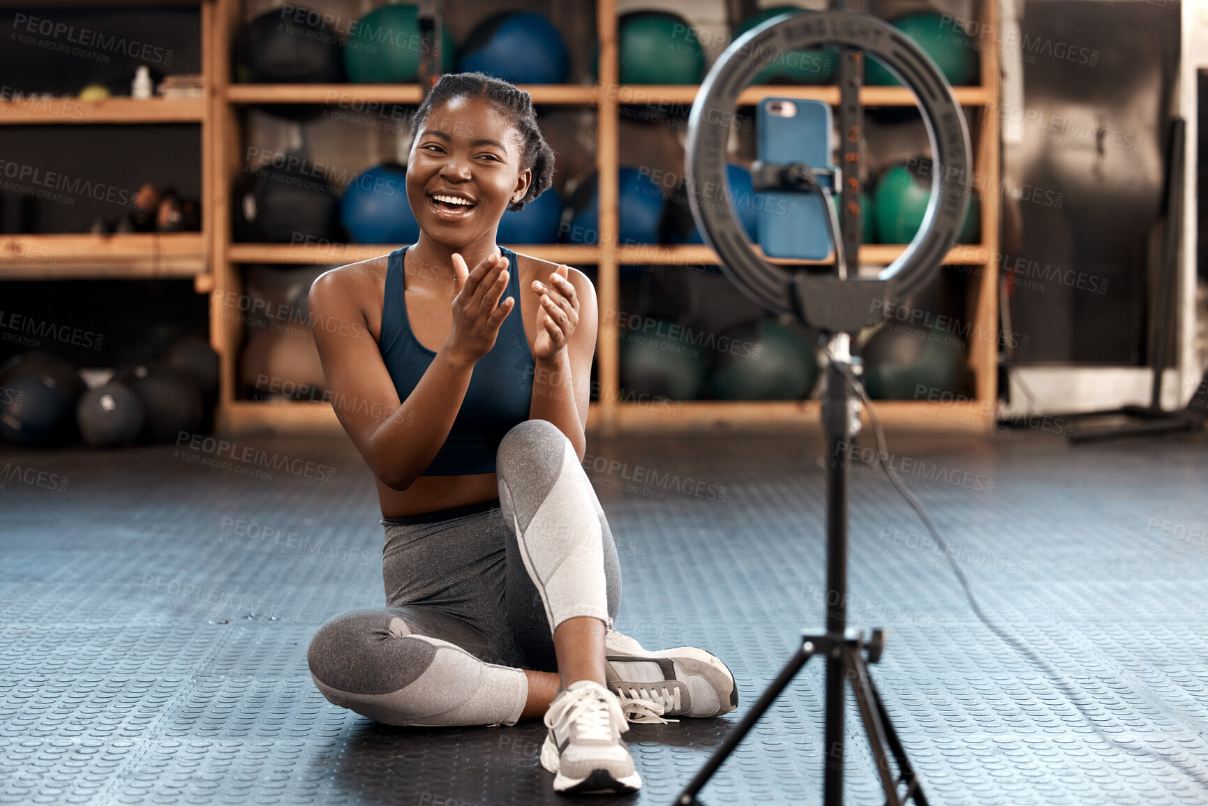 Buy stock photo Fitness, woman and phone blog for live stream exercise at gym on platform or app. Influencer, training or health vlog with black person or coach talking to social media or virtual audience with light