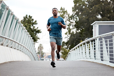 Buy stock photo Black man, fitness and running on bridge in city for cardio exercise, workout or training outdoors. Fit, active and sporty African male person, athlete or runner exercising on a run in an urban town
