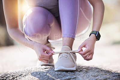 Buy stock photo Woman, hands and tie shoes for running, exercise or workout on asphalt road or street outdoors. Hand of female person or runner tying shoe getting ready for walk, run or fitness exercising in nature