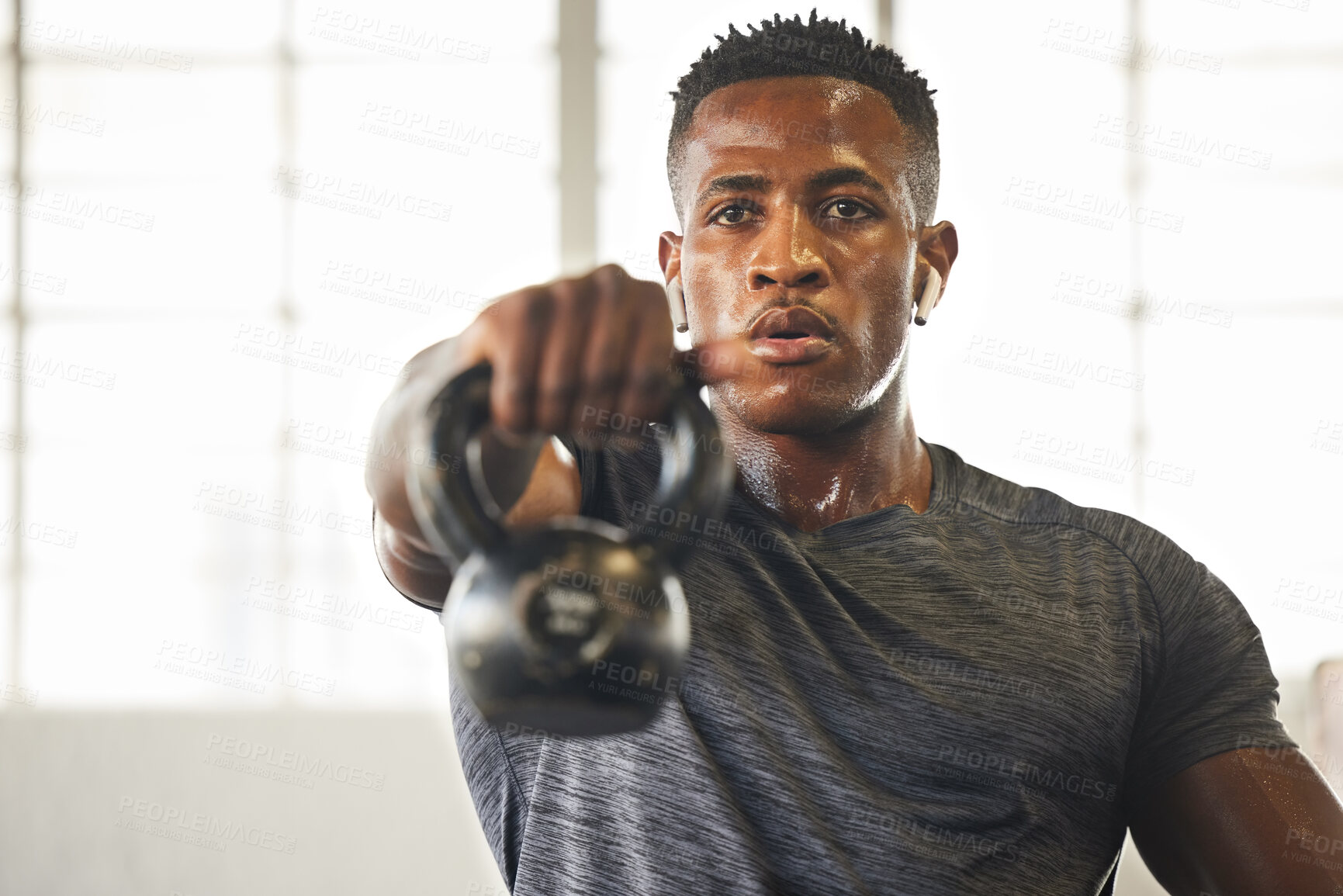 Buy stock photo Kettlebell, fitness and black man with gym workout, bodybuilder challenge and training with health and focus. Young athlete or professional person sweating for sports exercise, muscle and power goals