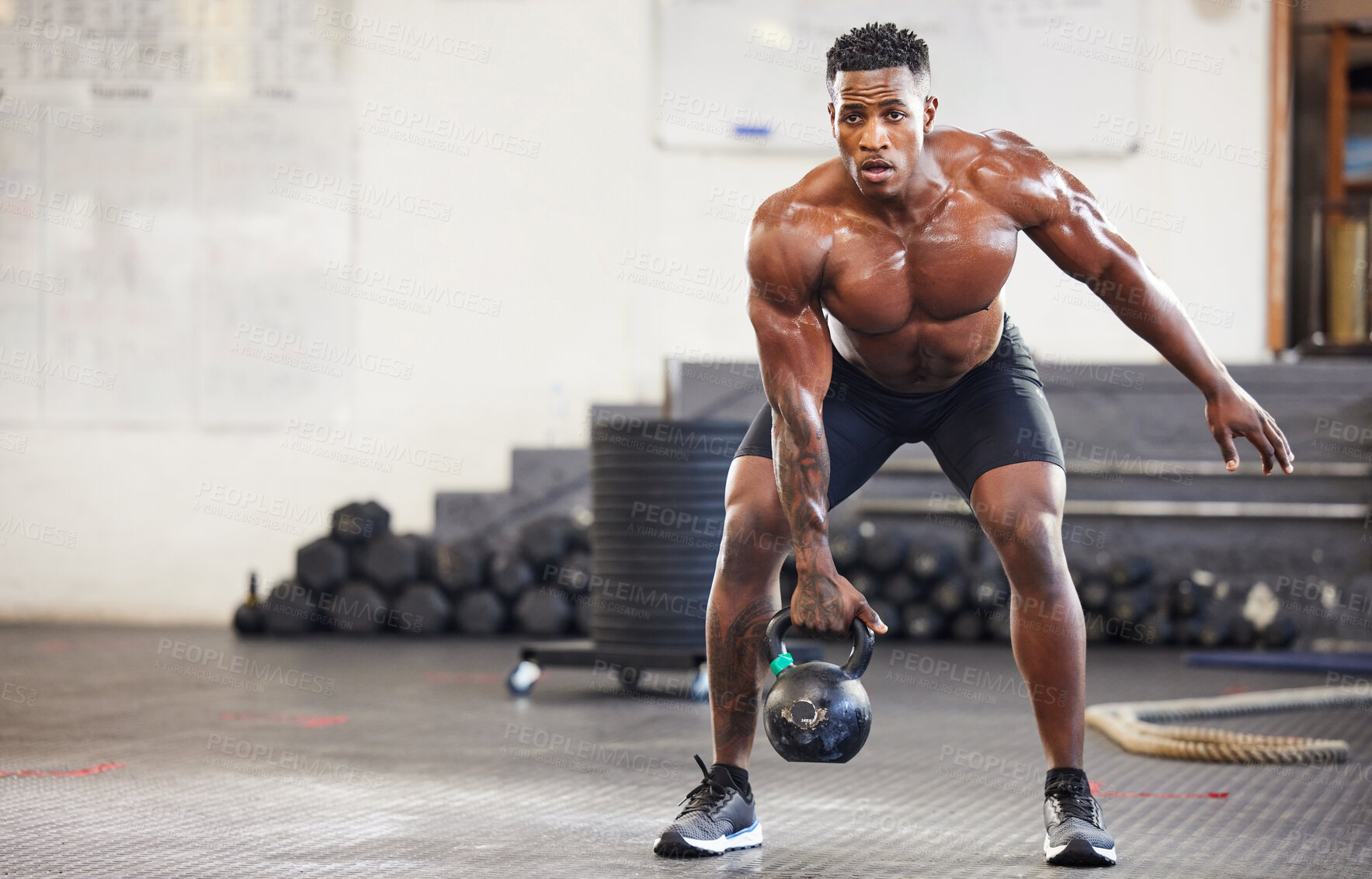 Buy stock photo Black man, fitness and weightlifting with kettlebell for workout, exercise or training at the gym. African male person or muscular bodybuilder lifting weight for strength sports or intense exercising