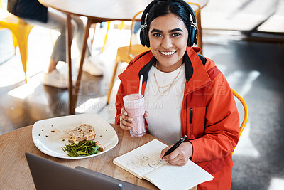 Buy stock photo Shot of a young female student having lunch while studying at college