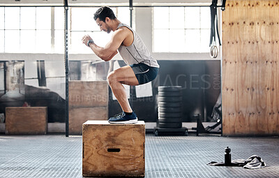 Buy stock photo Shot of a young man doing leg exercises at gym