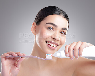 Buy stock photo Portrait, woman and brushing teeth with smile, dental hygiene and cavity on grey studio background. Face, person or model with oral care, mouth health and cleaning with veneers, aesthetic or wellness