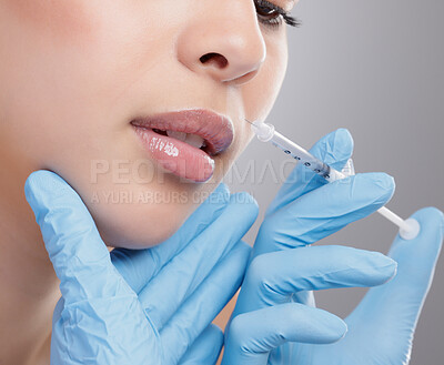 Buy stock photo Closeup shot of an attractive young woman having some plastic surgery done in studio against a grey background