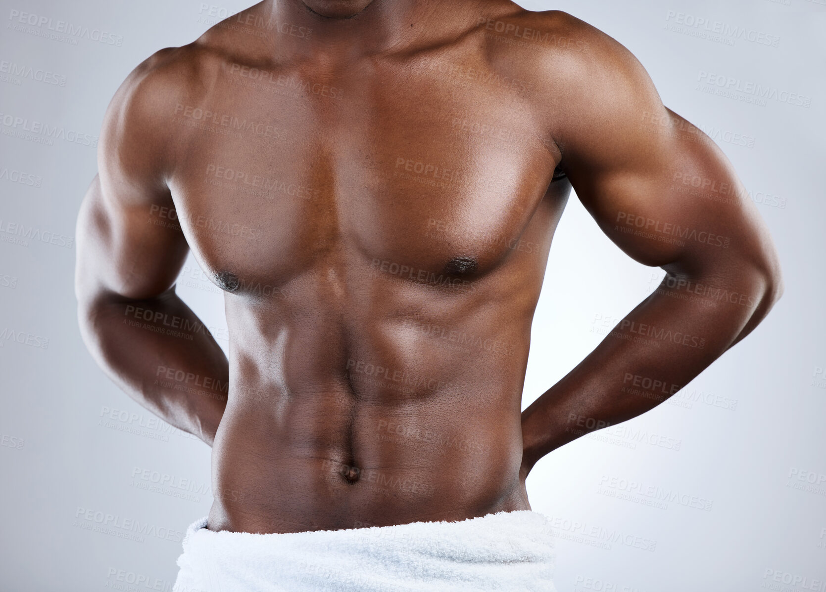 Buy stock photo Studio shot of an unrecognizable musclar man in a towel against a grey background