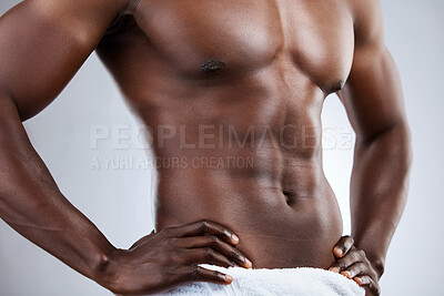 Buy stock photo Studio shot of an unrecognizable musclar man in a towel against a grey background