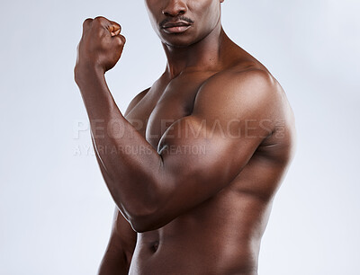 Buy stock photo Cropped shot of an unrecognizable musclar man flexing in studio against a grey background