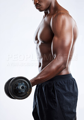 Buy stock photo Studio shot of an unrecognizable muscular man working out with a dumbbell against a grey background