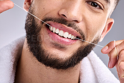 Buy stock photo Face, man and flossing teeth for dental health in studio isolated on a white background. Portrait, floss and male model cleaning tooth for oral wellness, hygiene and healthy gums for fresh breath.