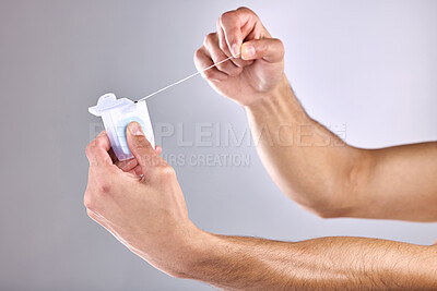 Buy stock photo Dental floss, hands and man in studio with clean, health and plaque removal morning routine. Dentistry, cosmetic and male person with oral hygiene product for mouth treatment by white background.