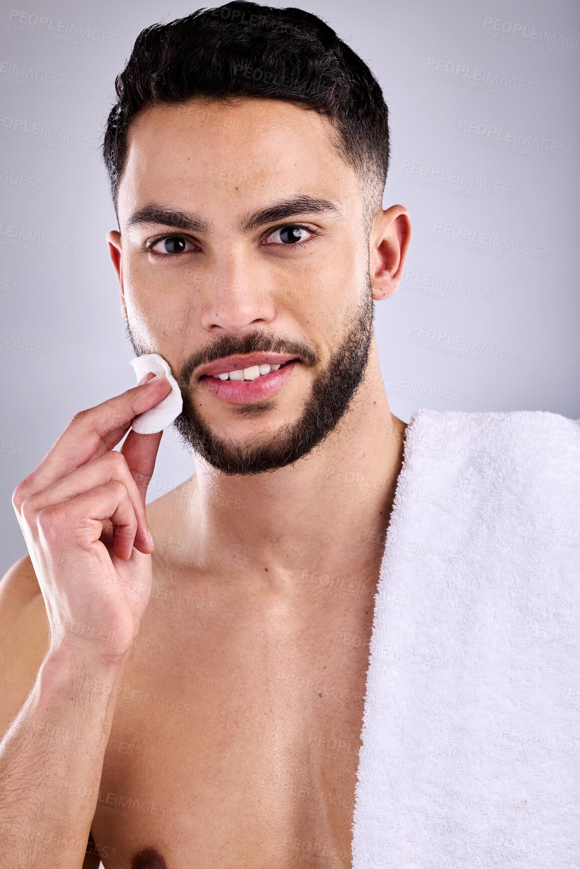 Buy stock photo Man, portrait and skincare with cotton pad for grooming or facial on a white studio background. Male person or model with smile or towel for hygiene, treatment or masculine beauty in dermatology