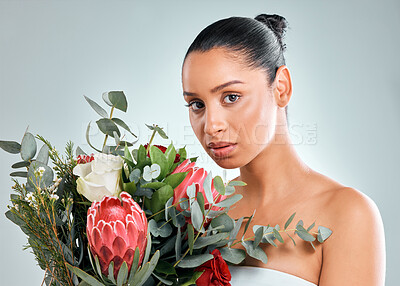 Buy stock photo Confident, woman and skincare with plant in studio on white background for organic or natural cosmetic. Female person, portrait and flower bouquet for skin glow, smooth and sustainability or wellness