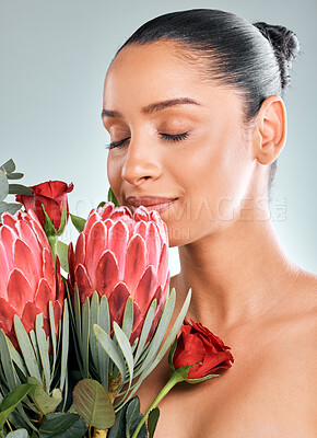 Buy stock photo Smell, woman and skincare with plant in studio on white background for organic or natural treatment. Female person, smile and protea flower for skin glow, smooth and sustainability or wellness