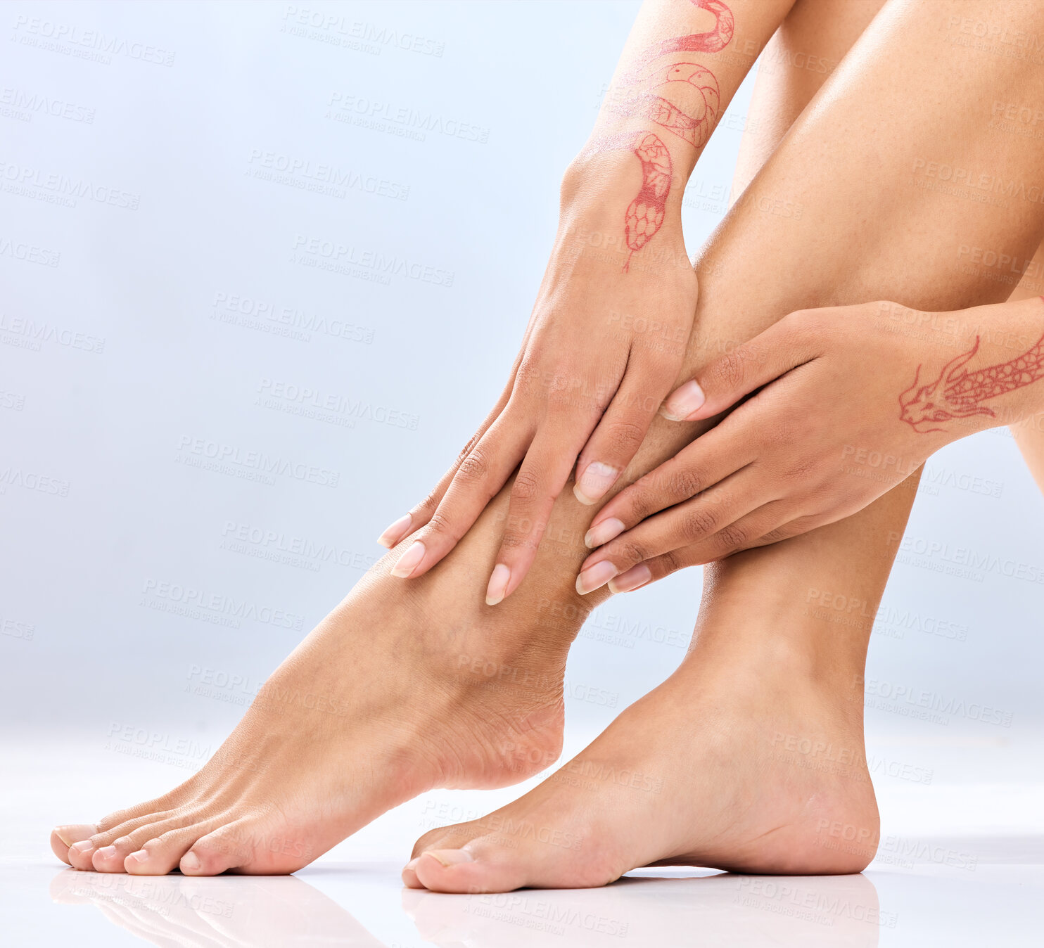 Buy stock photo Woman, legs and hands with depilation in skincare, grooming or hair removal waxing on a blue studio background. Closeup of female person, feet or beauty in laser treatment, cosmetology or dermatology