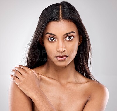 Buy stock photo Shot of a beautiful young woman posing against a grey background