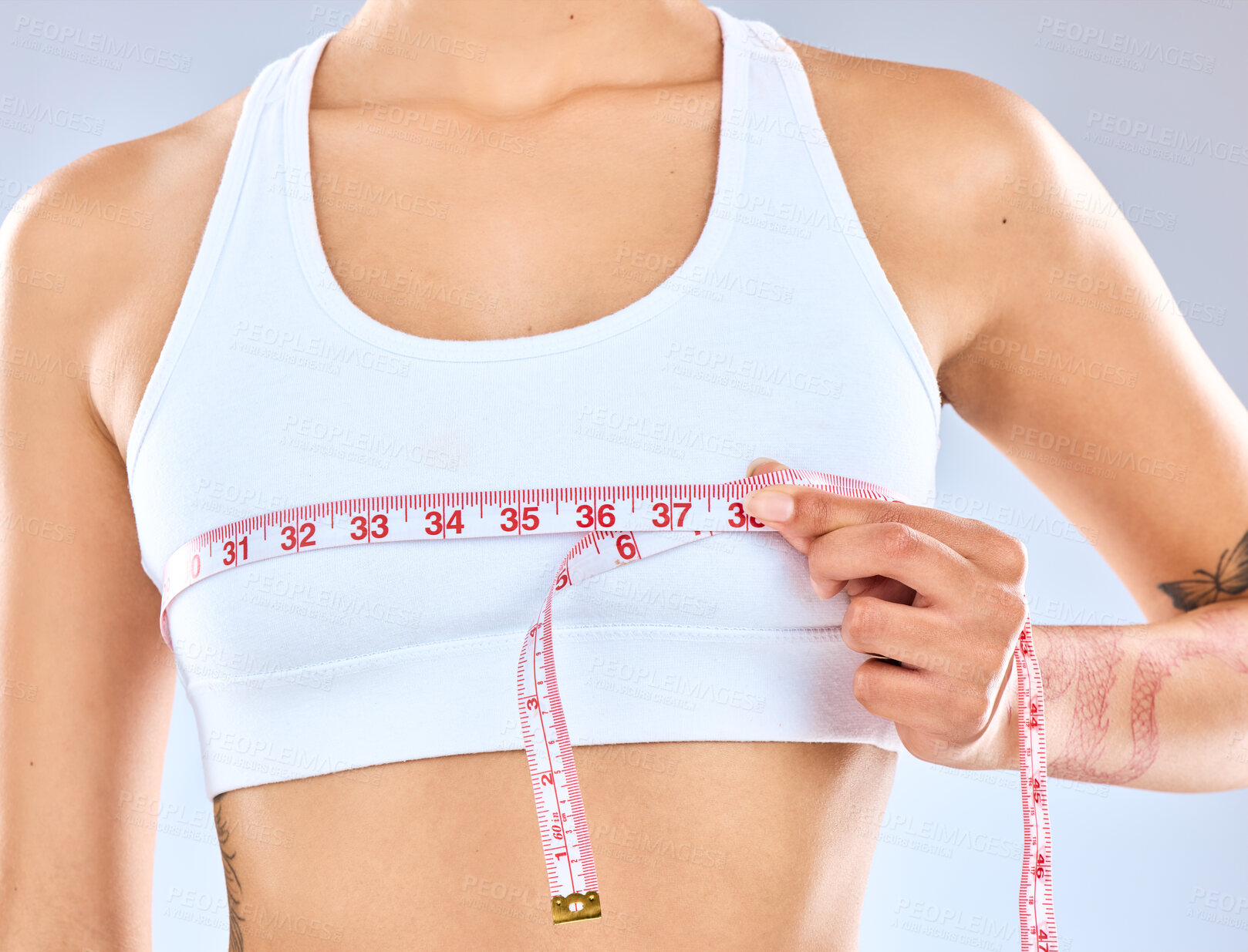 Buy stock photo Girl, measure and tape on boobs in studio for chest fitting or underbust measurement, growth and size for fitness or postpartum changes. Woman, isolated and white background with tracking breasts.