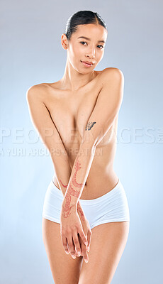 Buy stock photo Portrait of an attractive young woman  posing topless against a grey background