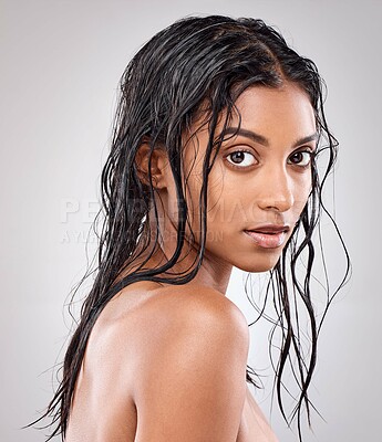 Buy stock photo Shot of a beautiful young woman posing against a grey background