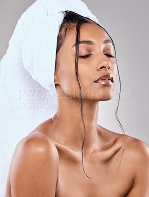 Buy stock photo Shot of a beautiful young woman posing against a grey background