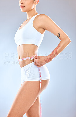 Buy stock photo Fitness, stomach and woman with tape measure in studio for weight loss, health progress and exercise goals on white background. Wellness, waist and model for detox, diet or body care with training