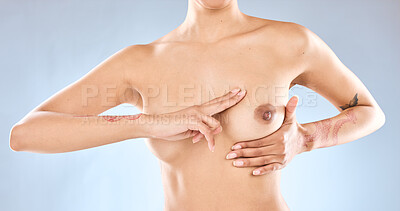 Buy stock photo Studio shot of an unrecognizable woman examining her breast