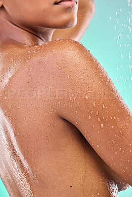 Buy stock photo Shot of an unrecognisable woman showering against a blue background