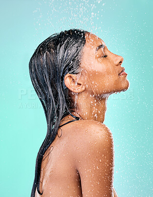 Buy stock photo Studio, water shower and woman for skincare with wellness, morning routine and safety from bacteria. Dermatology, liquid splash and Indian model with cleaning body for skin health by blue background