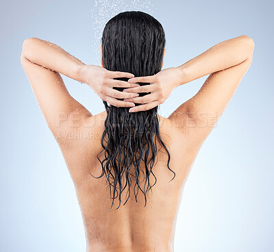 Buy stock photo Studio shot of an unrecognizable young woman taking a shower against a blue background