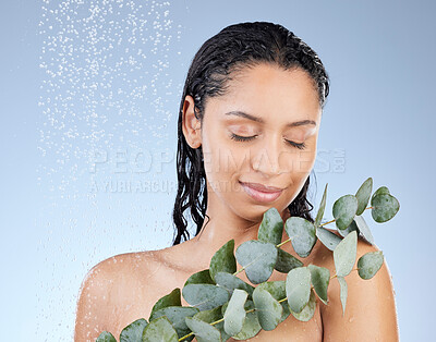 Buy stock photo Studio shot of an attractive young woman taking a shower against a blue background