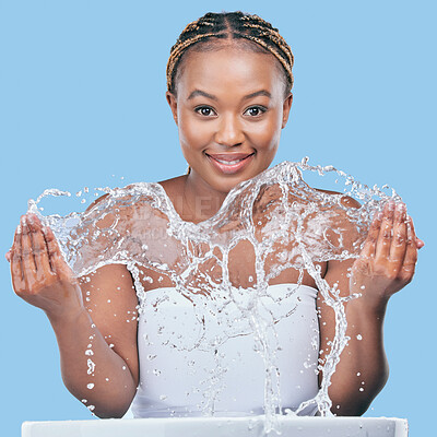 Buy stock photo Portrait, wet and black woman washing face, wellness and beauty on blue studio background. African person, smile and model with water splash, cleaning and grooming routine with hygiene and skincare