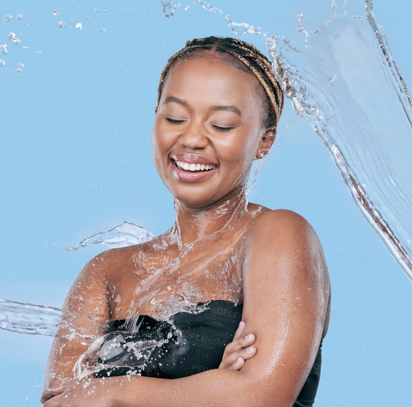 Buy stock photo Water splash, wellness and black woman in studio with natural, beauty and facial routine. Cosmetic, dermatology and African female person washing face with h2o liquid for skincare by blue background.