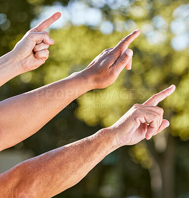 Buy stock photo Shot of a group of unrecognisable men pointing upwards outdoors