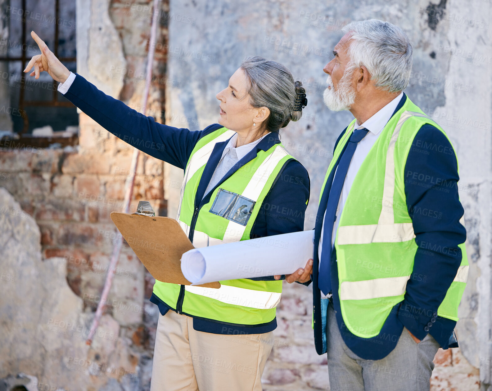 Buy stock photo Mature, business people and clipboard with blueprints at construction site for property development. Senior team, project manager and architect with building plans for house renovation and inspection