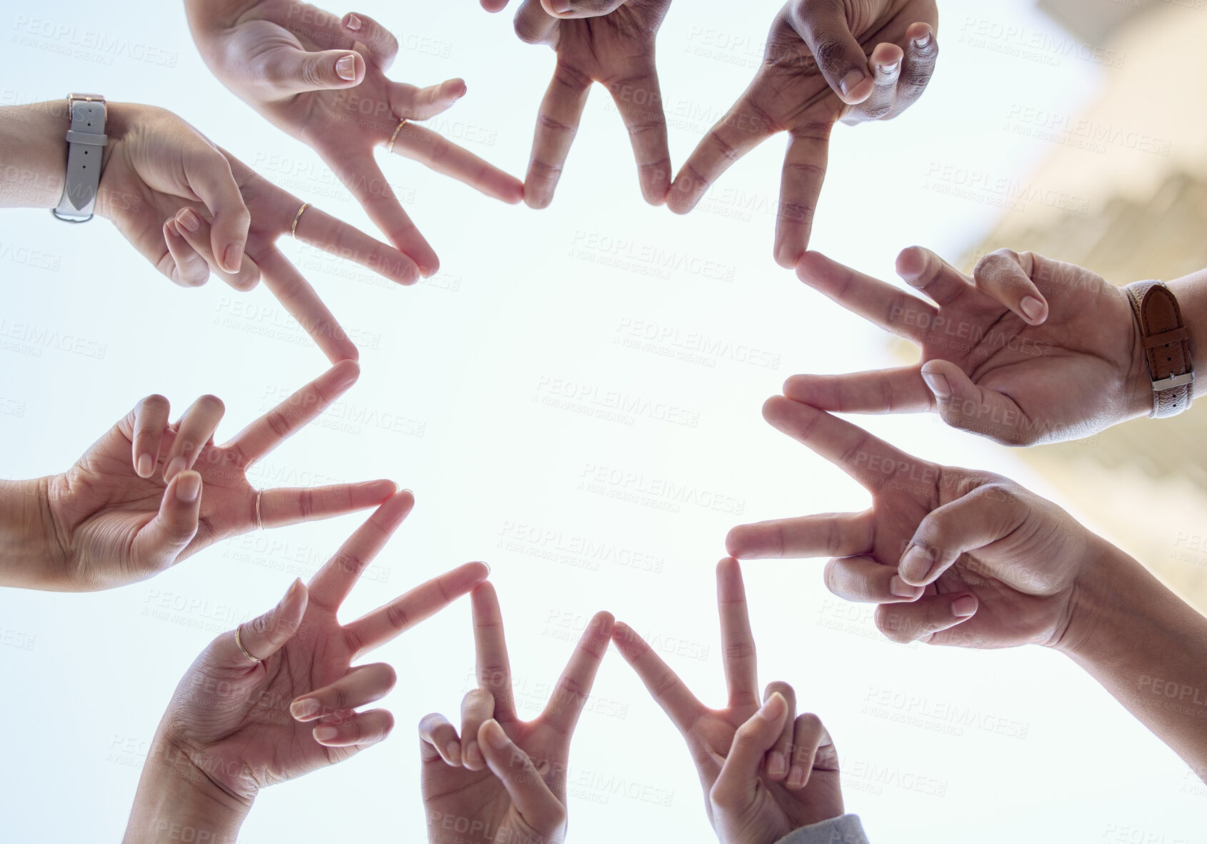 Buy stock photo Hands, sky and people with finger stars for synergy or unity above with teamwork, low angle and diversity. Group, shape and sign for solidarity with collaboration, community and huddle with peace.