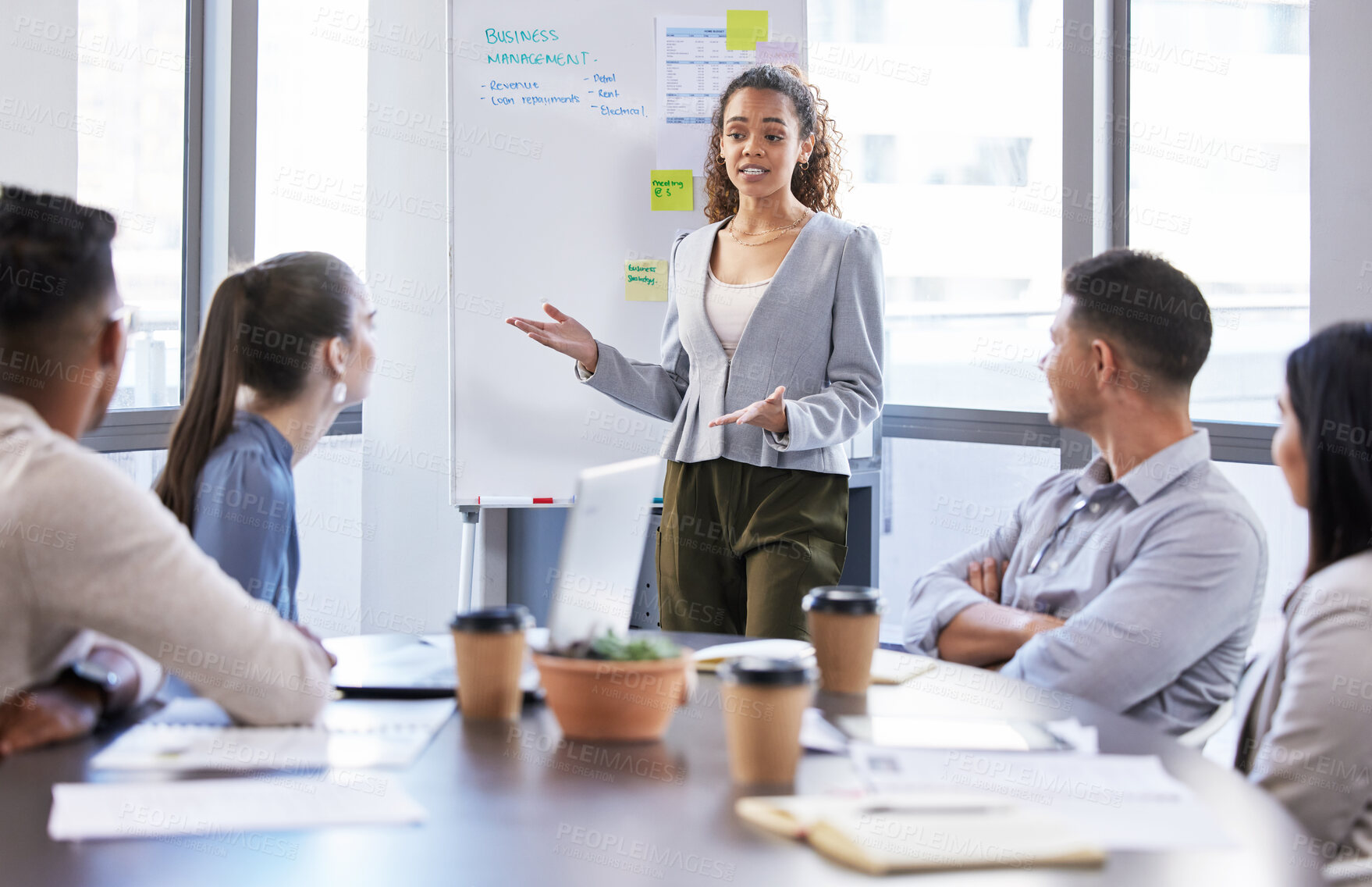 Buy stock photo Shot of a young businesswoman giving a presentation