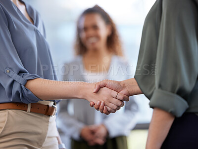 Buy stock photo Shot of unrecognisable businesswomen shaking hands in a modern office