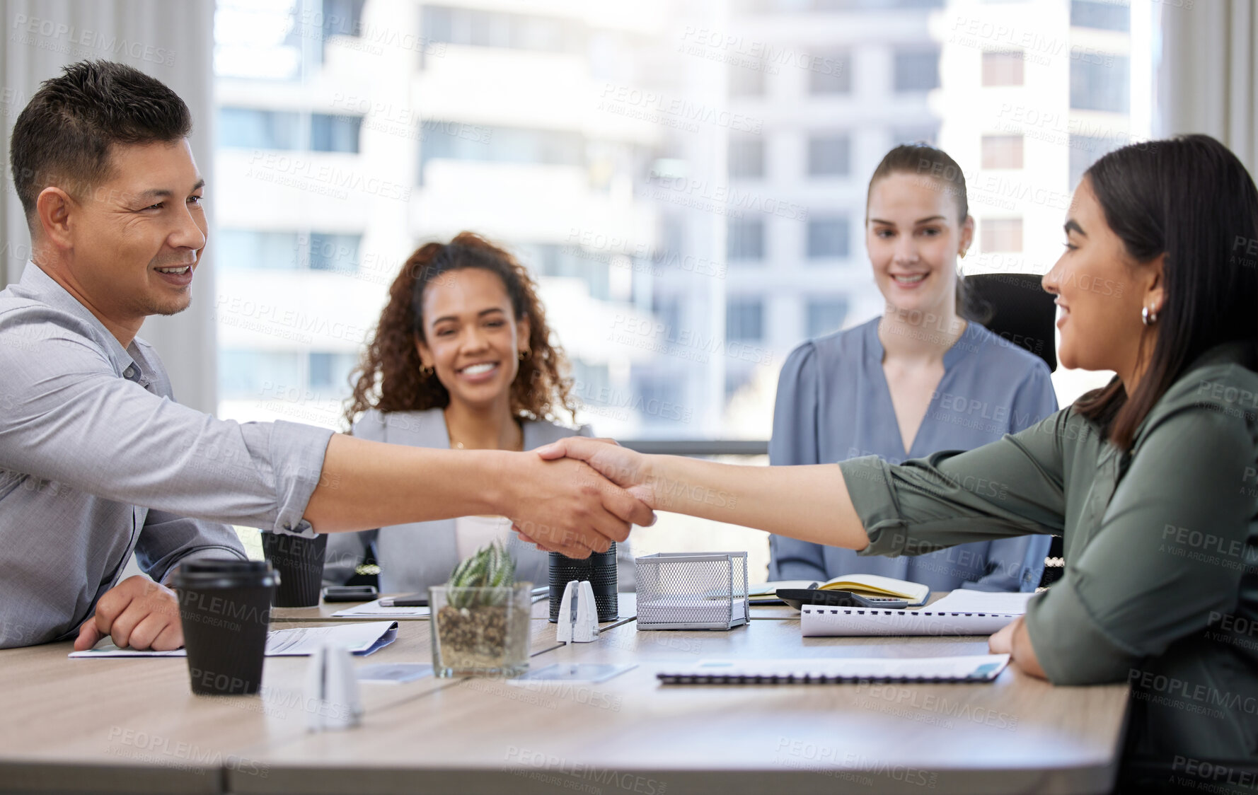 Buy stock photo Shot of two businesspeople shaking hands in a meeting at work