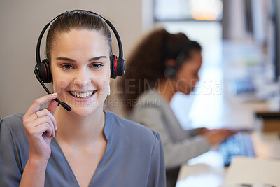 Buy stock photo Portrait of a young call centre agent working in an office with her colleagues in the background