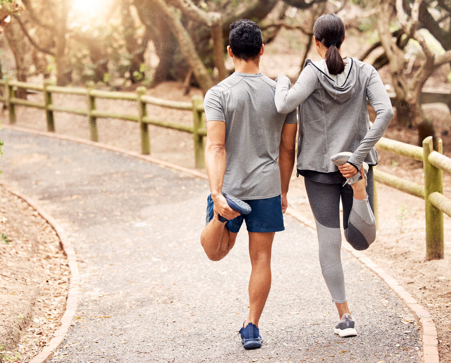 Buy stock photo Stretching, back and legs of couple, outdoor and fitness for performance, road and exercise for body. Street, athlete and people together, healthy and training with workout, action and path in park